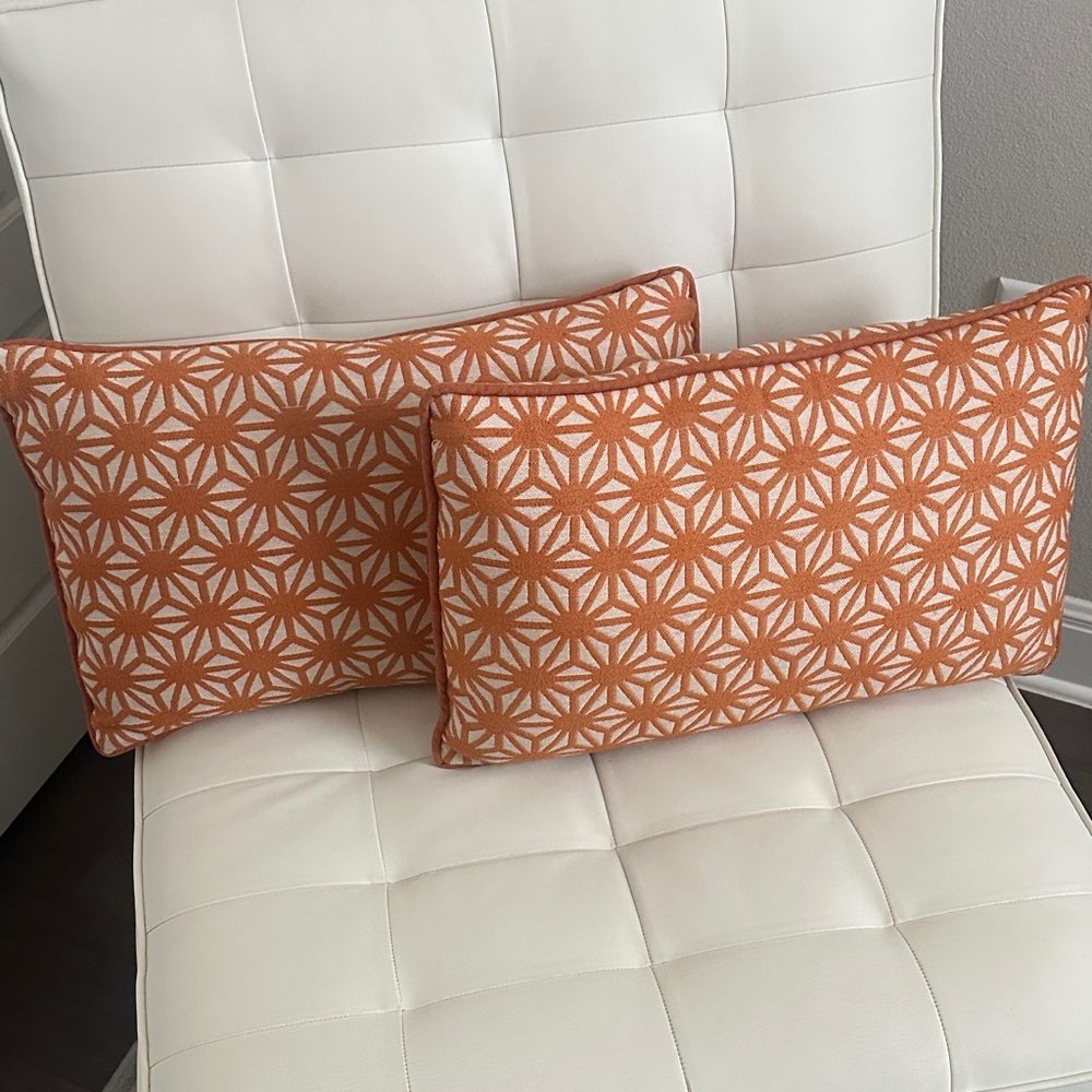 Two Orange and White Geometric Lumbar Pillows